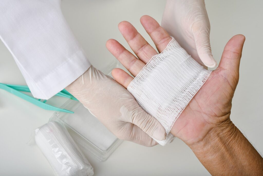 Doctor doing wound dressing care and bandaging patient's hand, Hand surgery treatment